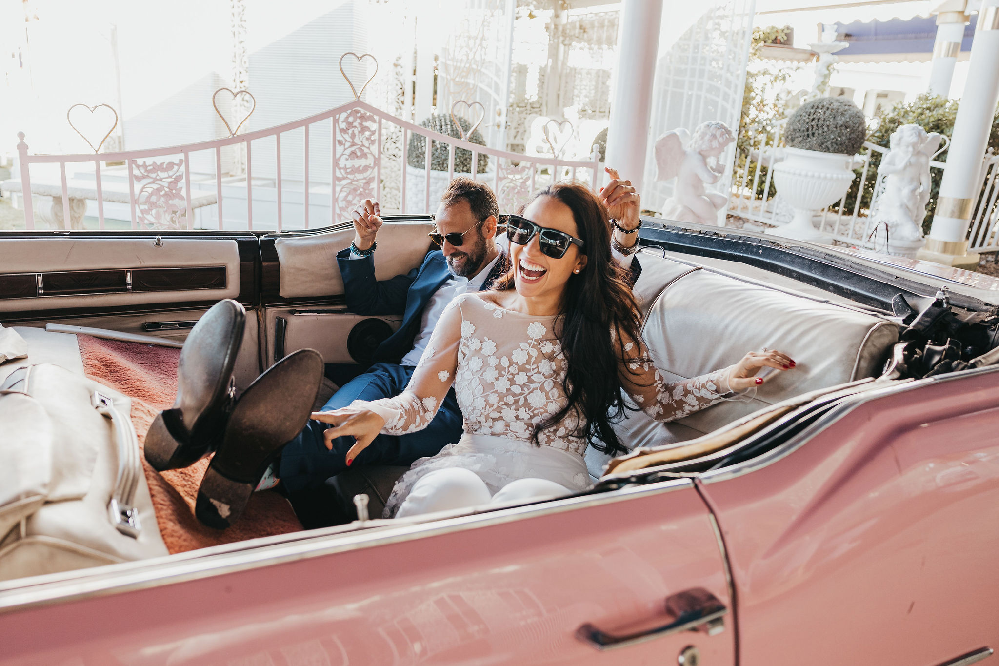 Couple celebrating elopement in vintage car