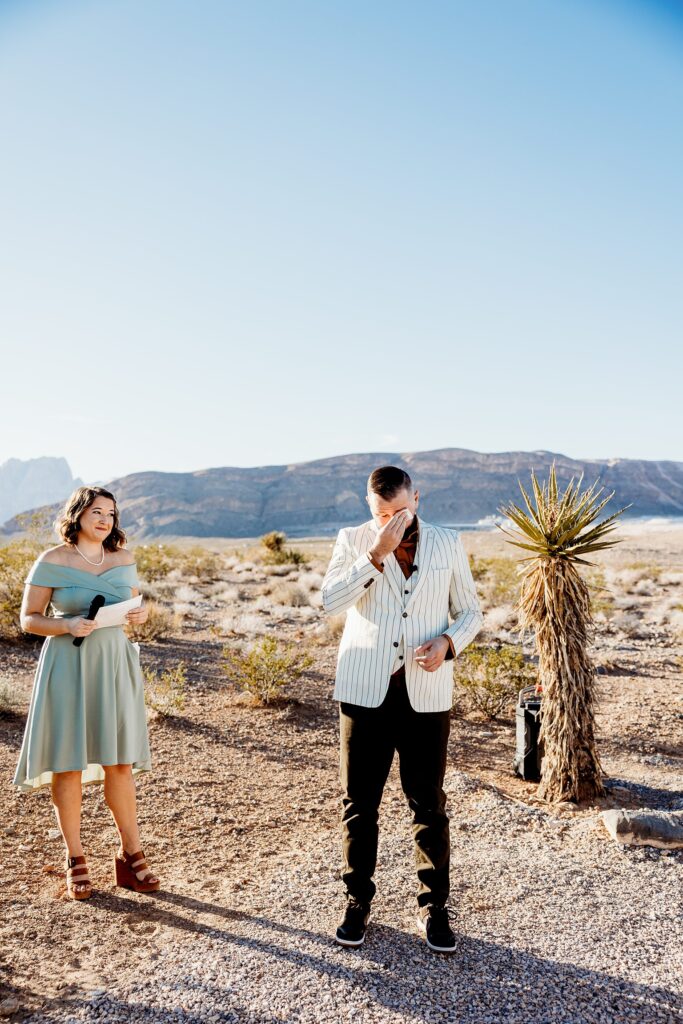 Groom getting emotional as he sees his bride walking down the aisle for their Cactus Joe's wedding ceremony on Desert Love Land