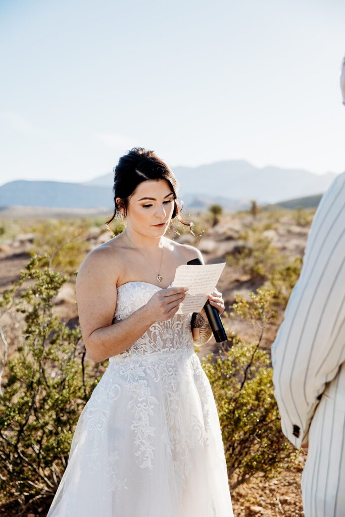 Bride reading her vows to her groom during their Cactus Joe's wedding ceremony on Desert Love Land