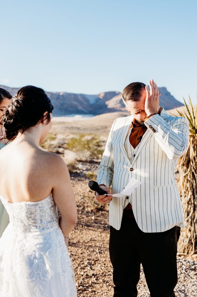 Groom getting emotional as the bride reads her vows to him during their Cactus Joe's wedding ceremony on Desert Love Land