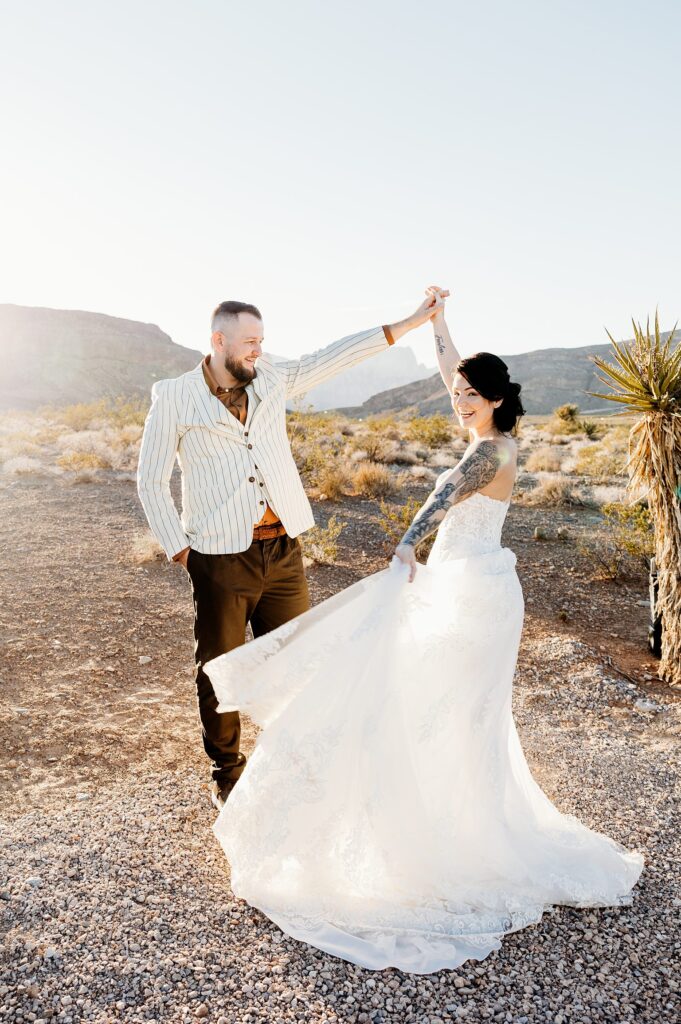 Groom twirling his bride during their Cactus Joe's wedding on Desert Love Land