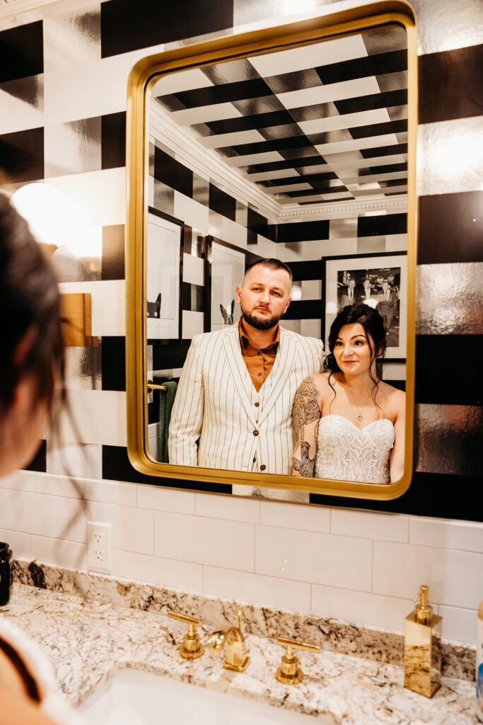 Bride and groom posing in a mirror at Mid Century Manor in Las Vegas