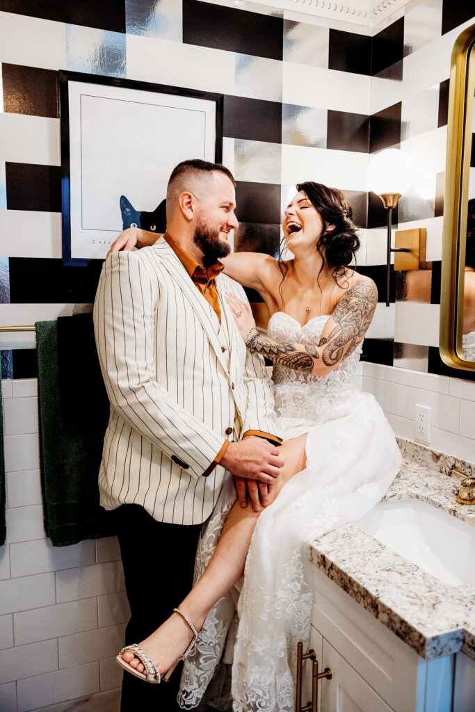 Bride and groom posing in a bathroom at Mid Century Manor in Las Vegas