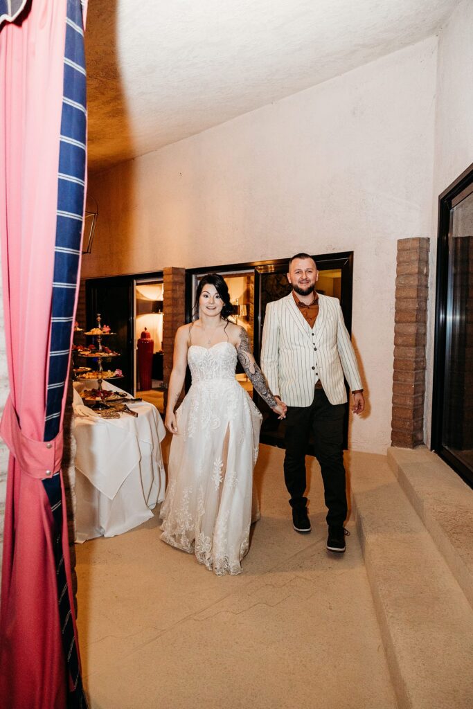 Bride and groom entering their wedding reception