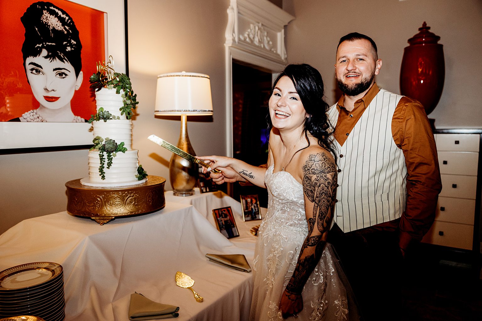 Bride and groom cutting into their wedding cake