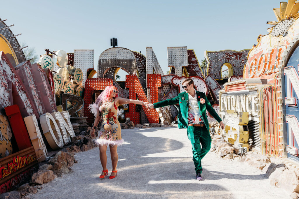 bride and groom exploring the neon museum