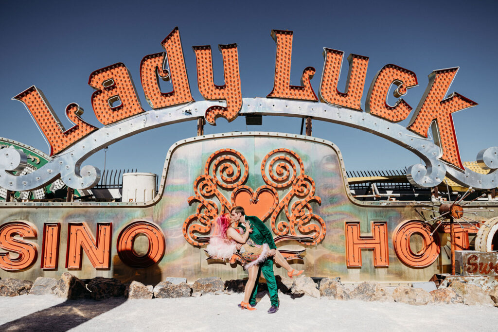 cute portrait of the newlyweds kissing at the neon museum