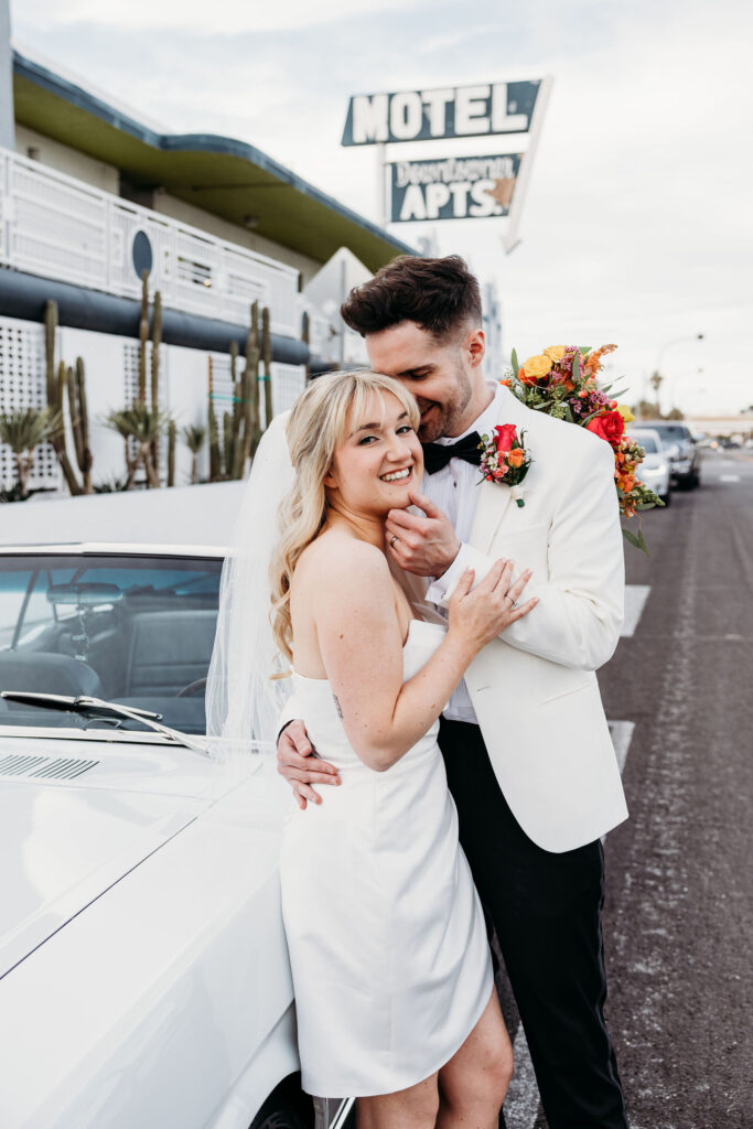groom kissing the bride on the cheek