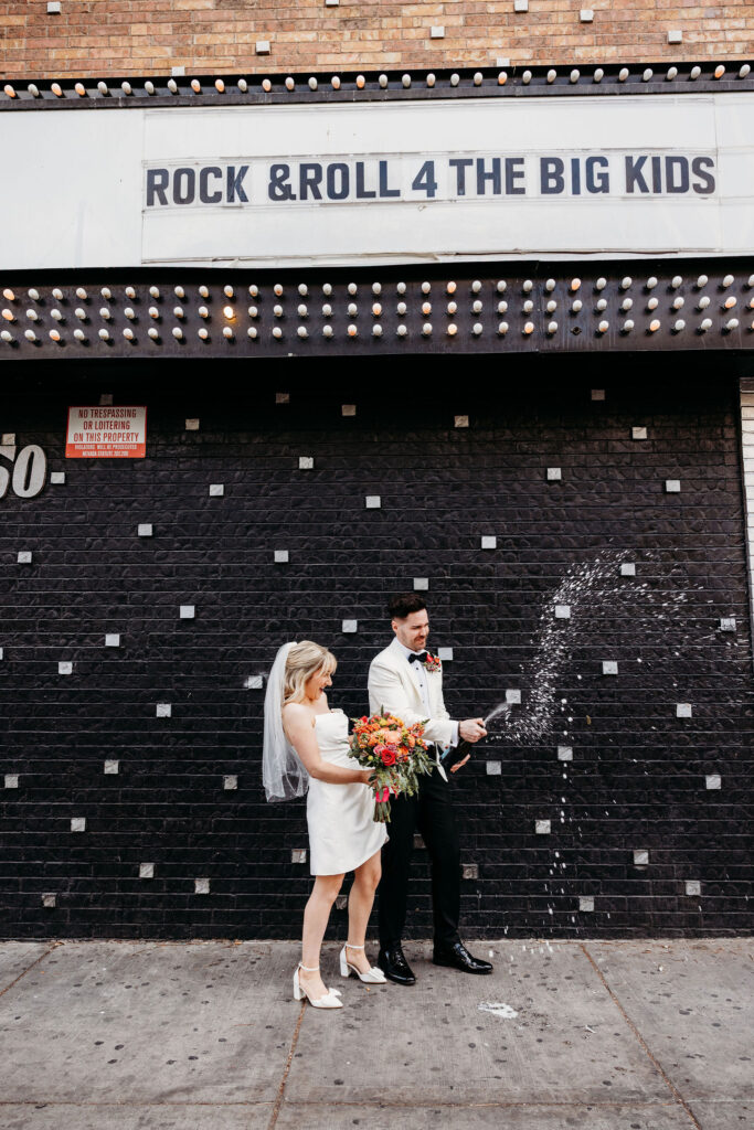 cute couple celebrating during their elopement with champagne