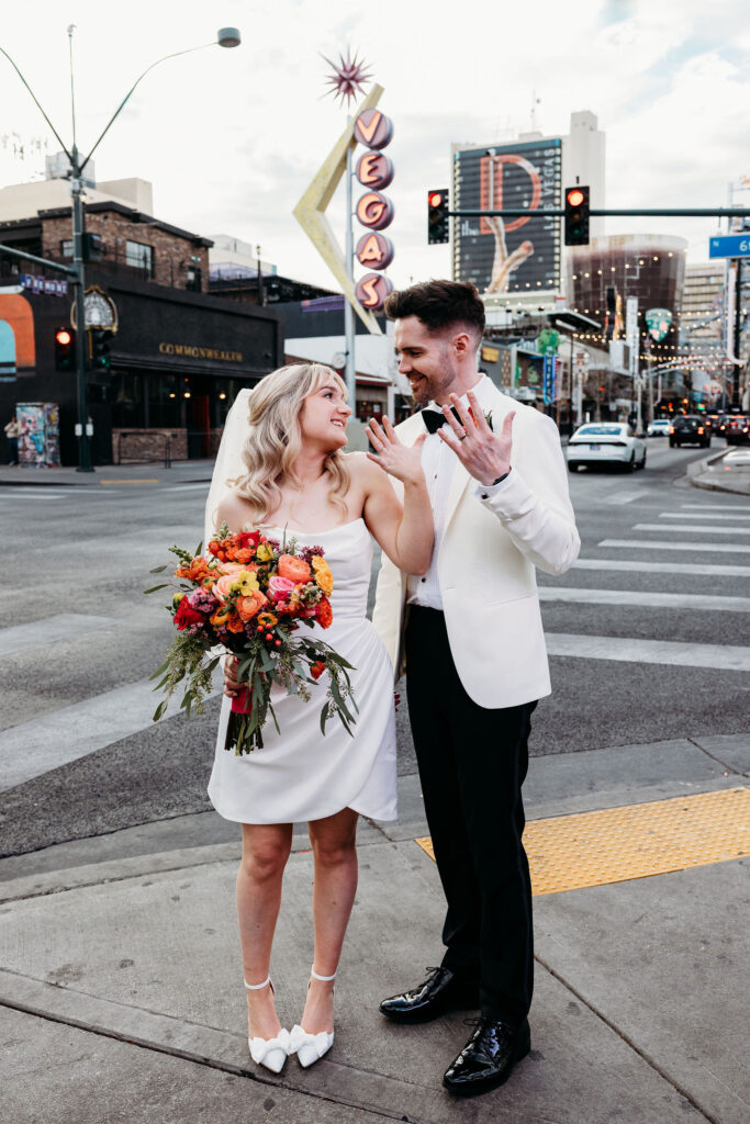couple showing their wedding rings during their photoshoot