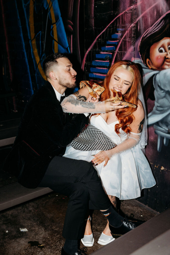 couple celebrating their elopement with pizza