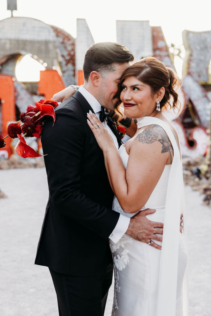 picture of the groom kissing the bride on the cheek