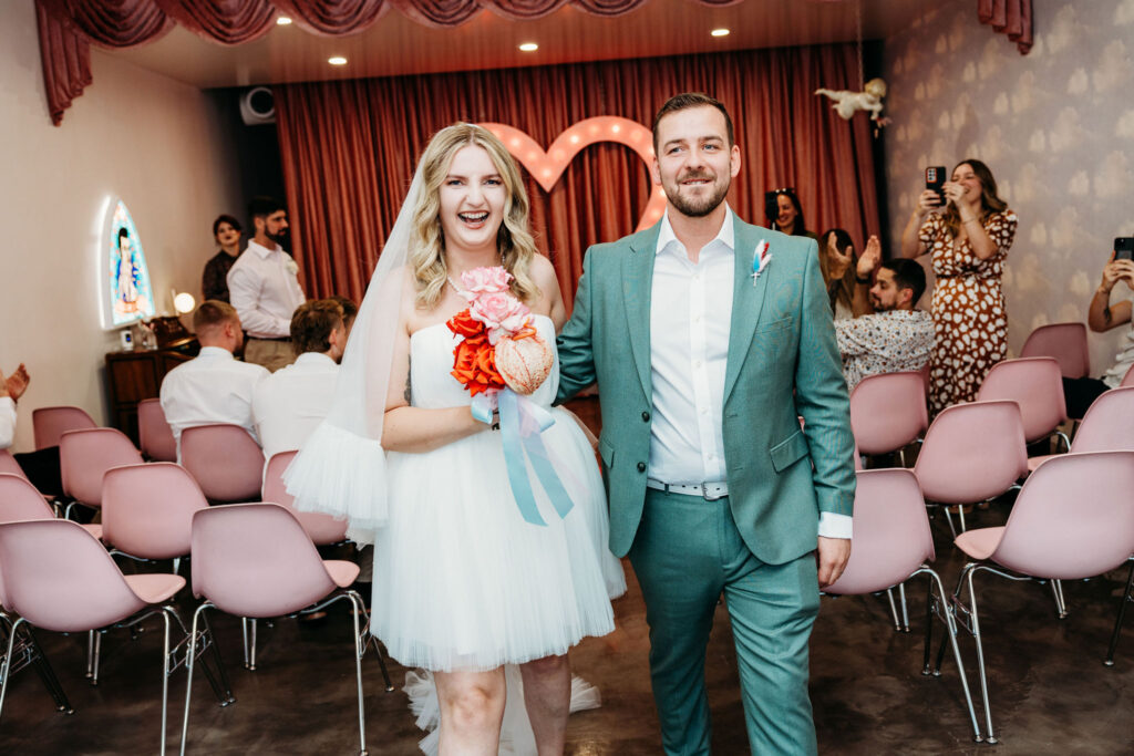 couple smiling at the camera during their photos after the ceremony