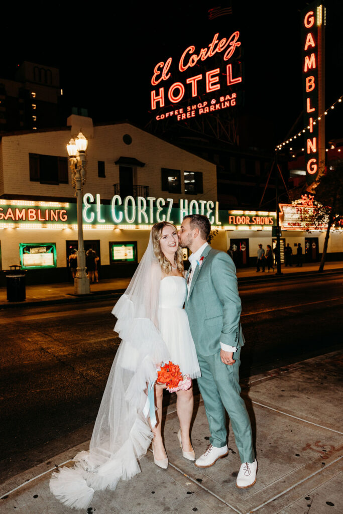 groom kissing the bride on the cheek