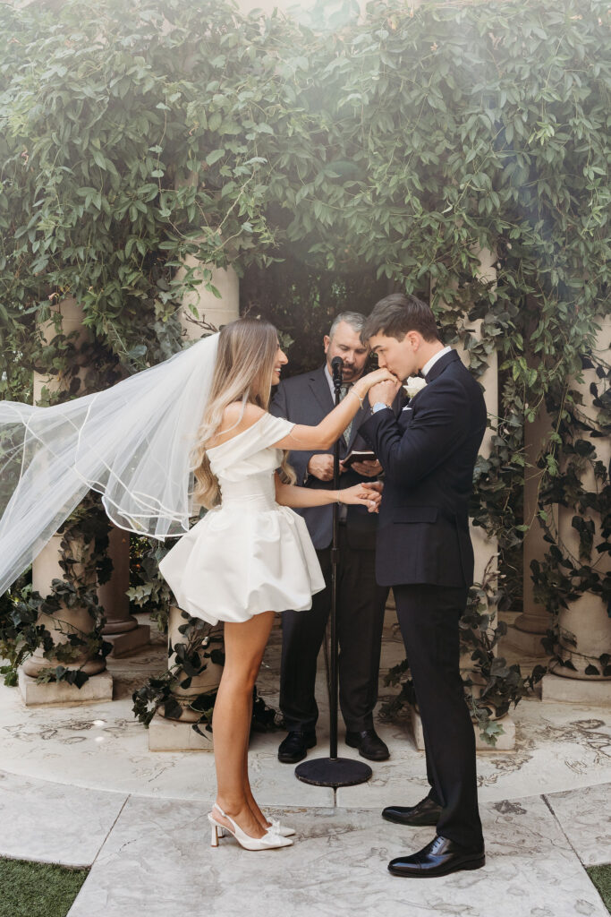 Groom, kissing the brides hand