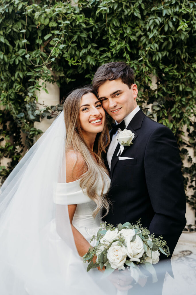 Bride and groom, smiling at the camera during their bridal portraits