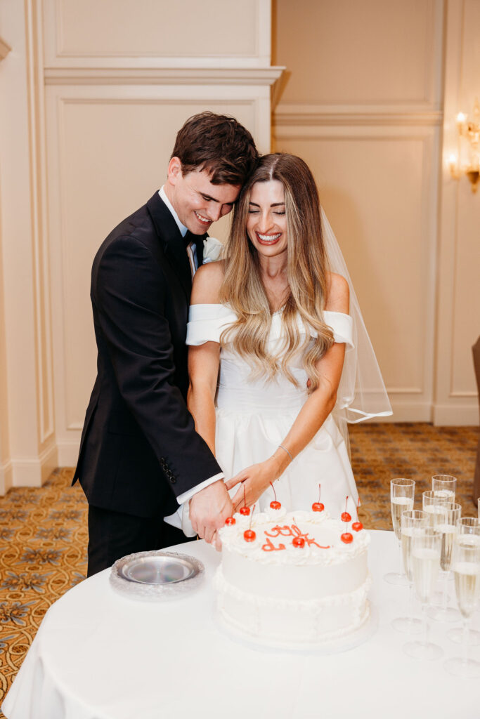 Newlyweds cutting their wedding cake