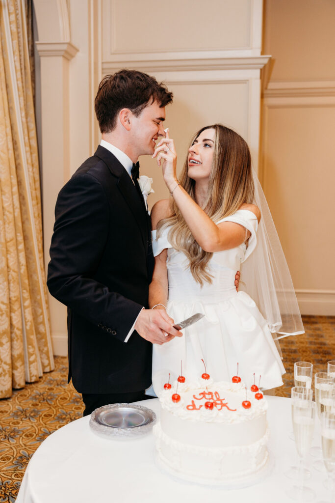 Couple trying their wedding cake