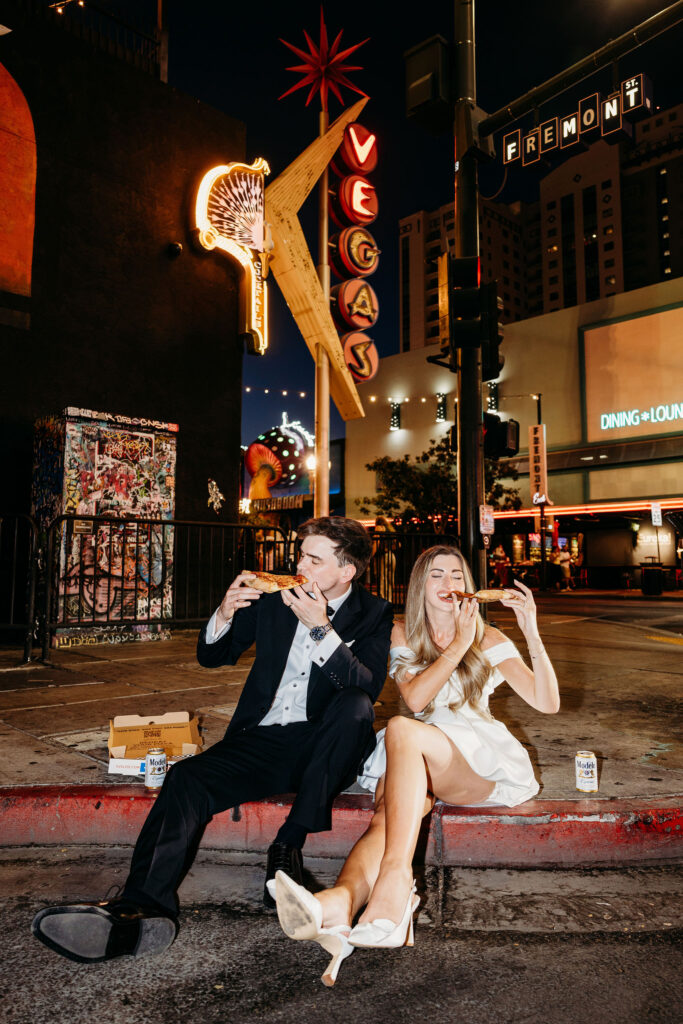 Couple celebrating their wedding with pizza