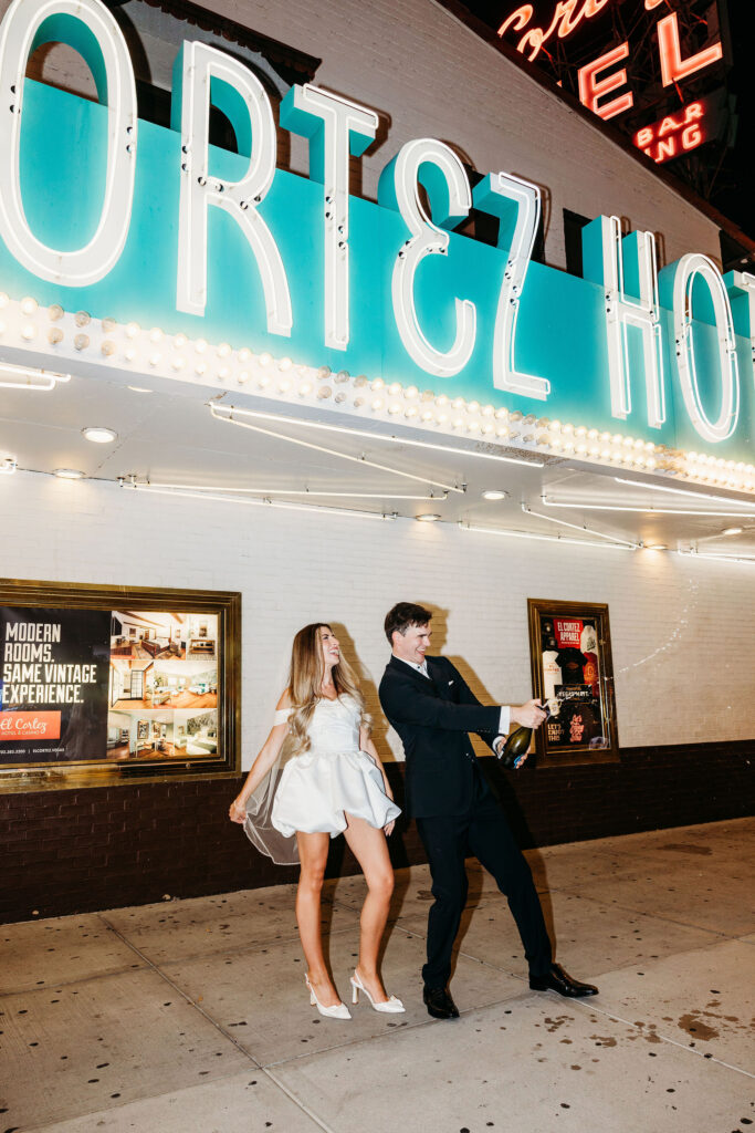 Happy couple celebrating their elopement with champagne
