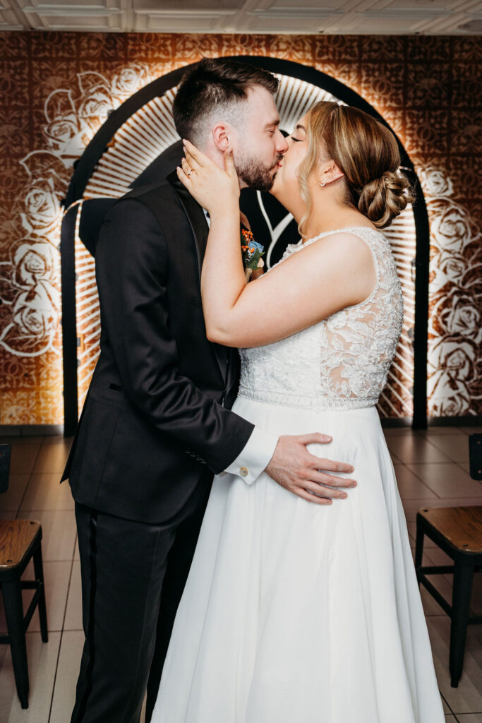 bride and groom kissing after their ceremony