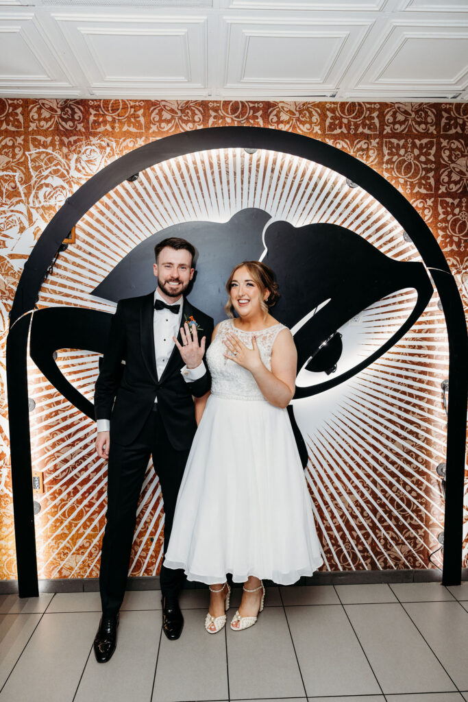 portrait of the bride and groom showing their wedding rings