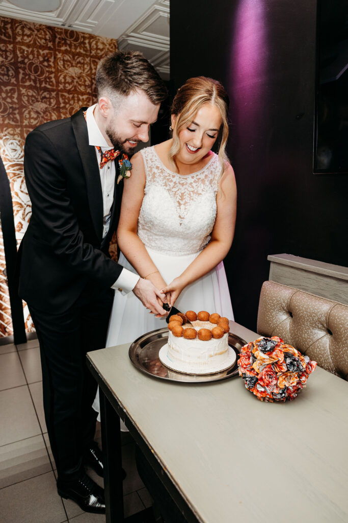 bride and groom cutting their elopement cake 