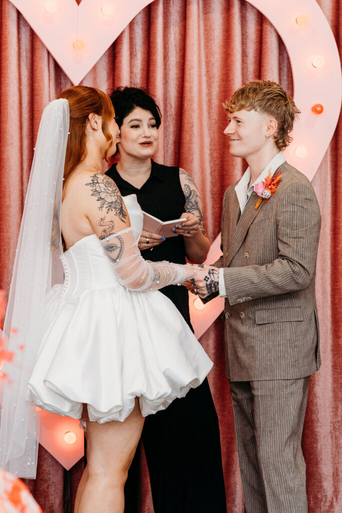 bride and groom holding hands during their ceremony