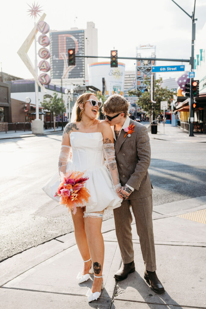 groom kissing the bride on the shoulder