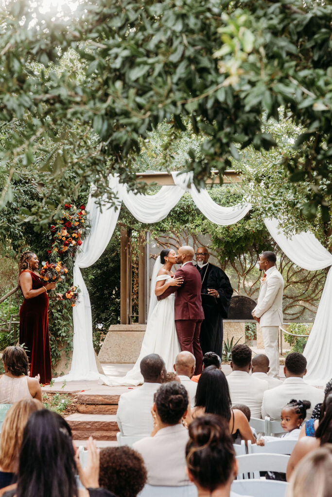 bride and groom kissing after the wedding ceremony
