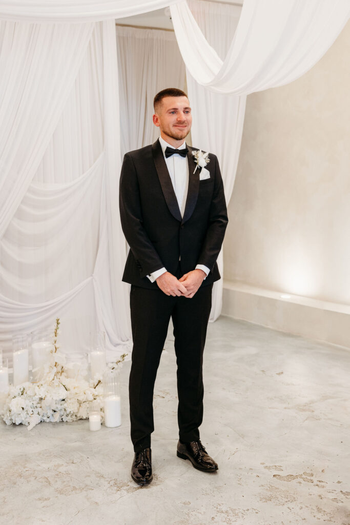 groom emotional watching the bride walk down the aisle