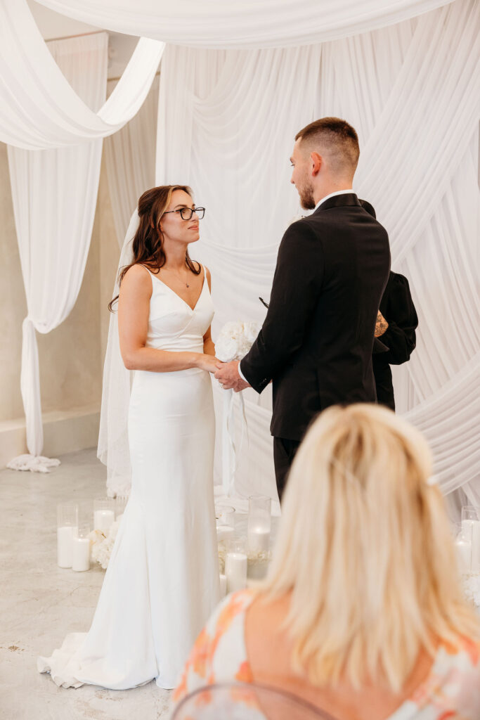 bride and groom holding hands during their wedding ceremony
