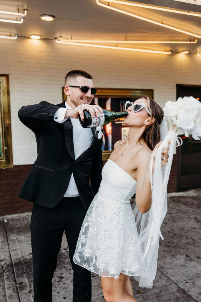 newlyweds celebrating their elopement with champgne