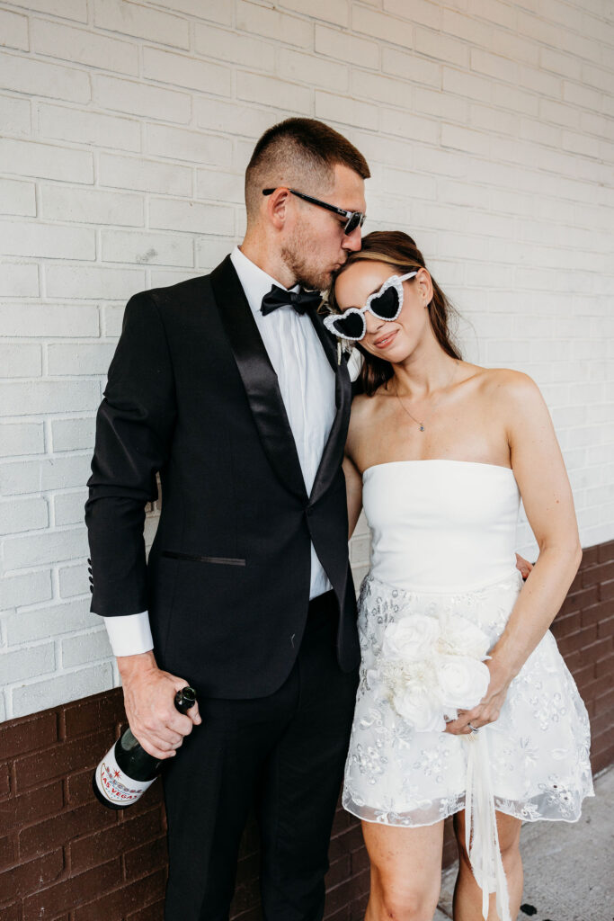groom kissing the bride on the forehead