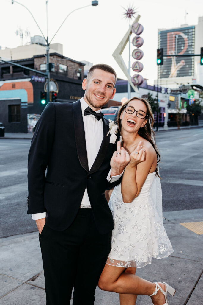 cute picture of the newlyweds showing their wedding rings