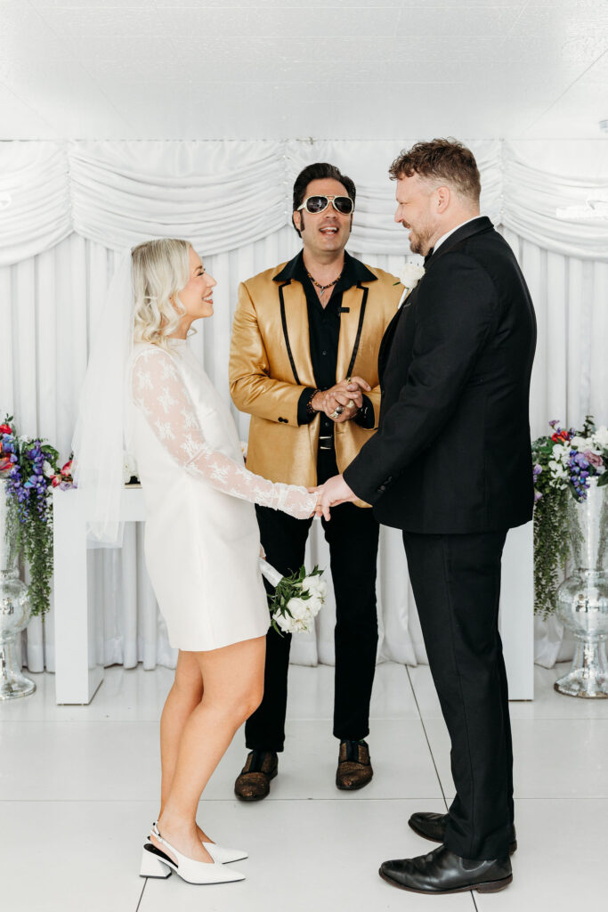 bride and groom holding hands during their ceremony
