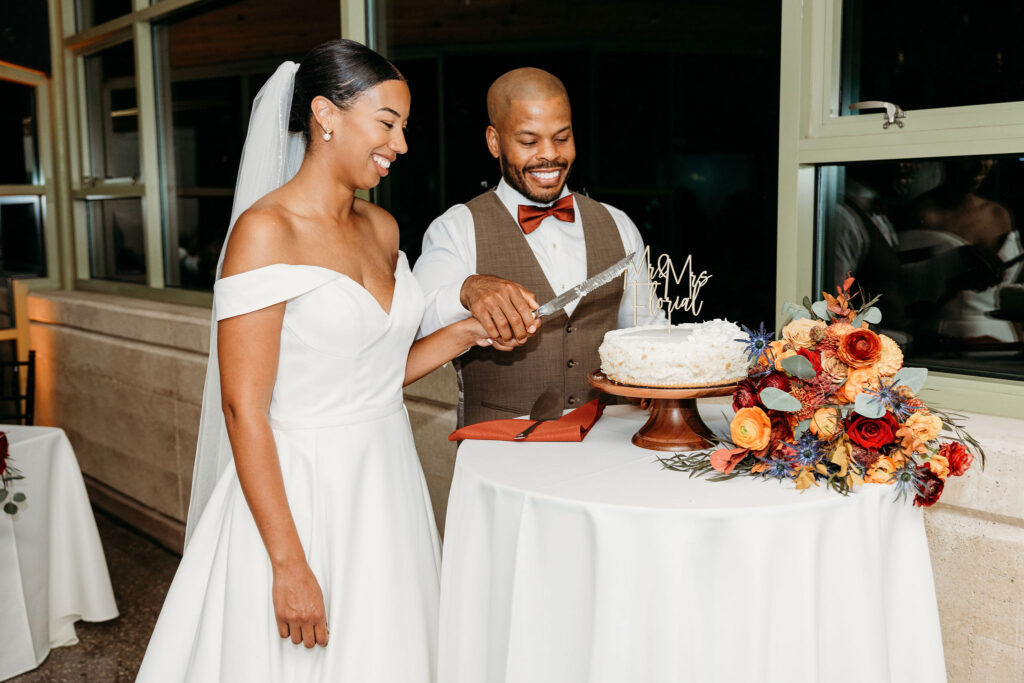 newlyweds cutting their wedding cake