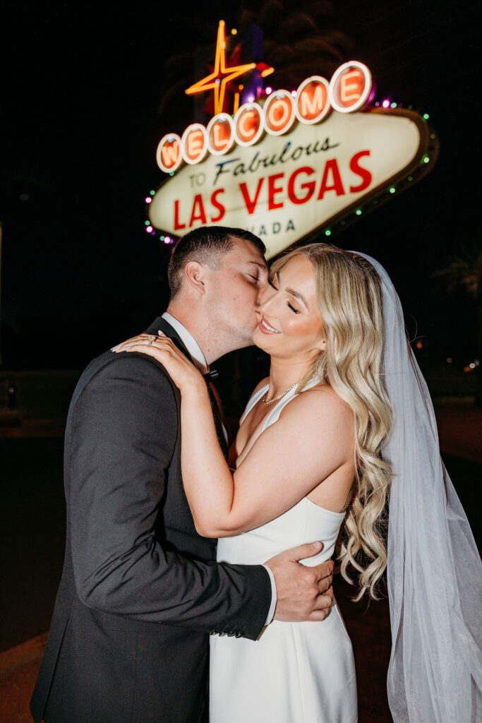 groom kissing the bride on the cheek