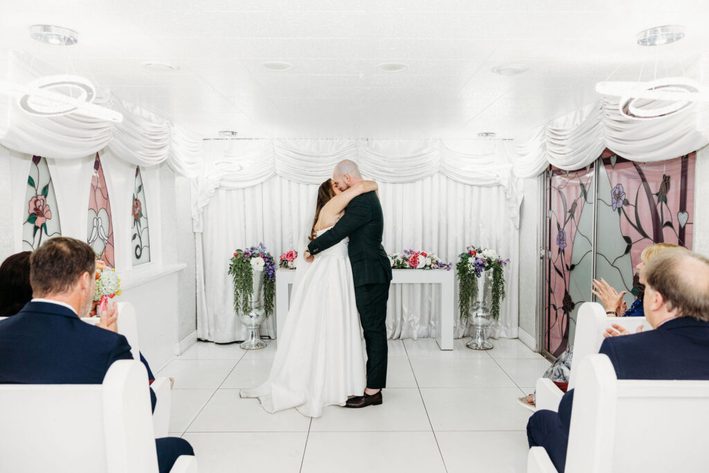 Cute picture of the bride and groom, kissing after their ceremony