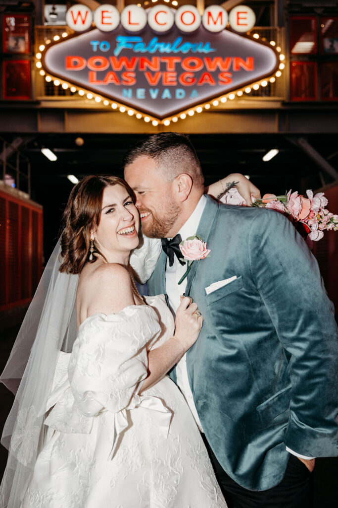 groom kissing the bride on the cheek