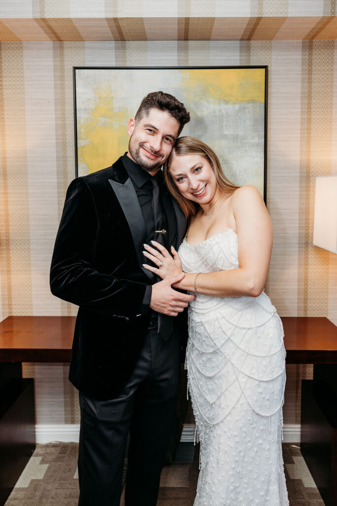 couple smiling at the camera during their photoshoot