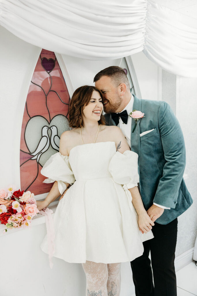 groom kissing the bride on the cheek