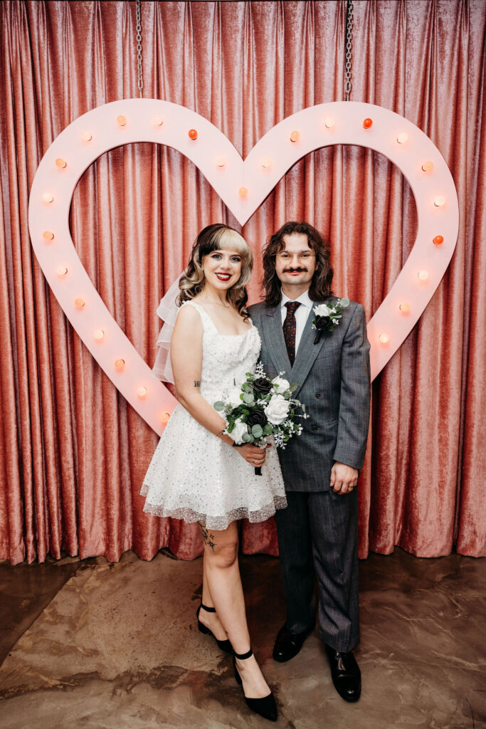 Newly married couple, smiling at the camera during their bridal portraits