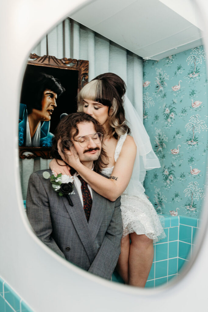 Bride, kissing the groom on the forehead