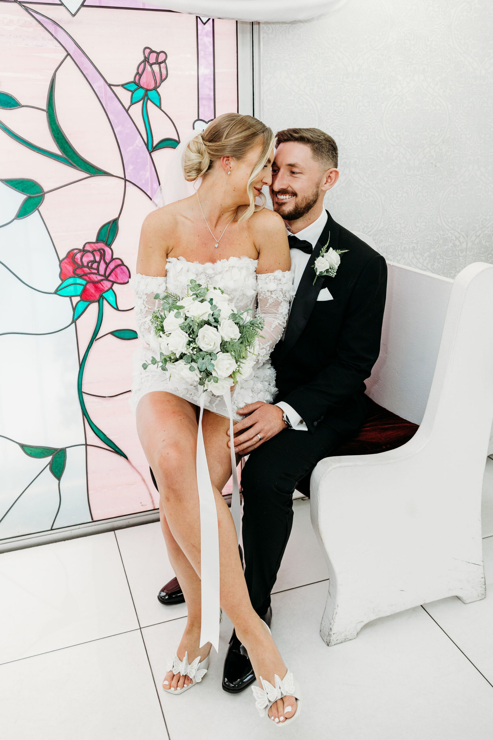 Groom, kissing the bride on the cheek