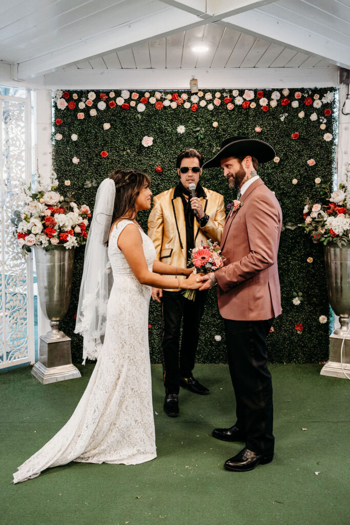 bride and groom holding hands during their wedding ceremony