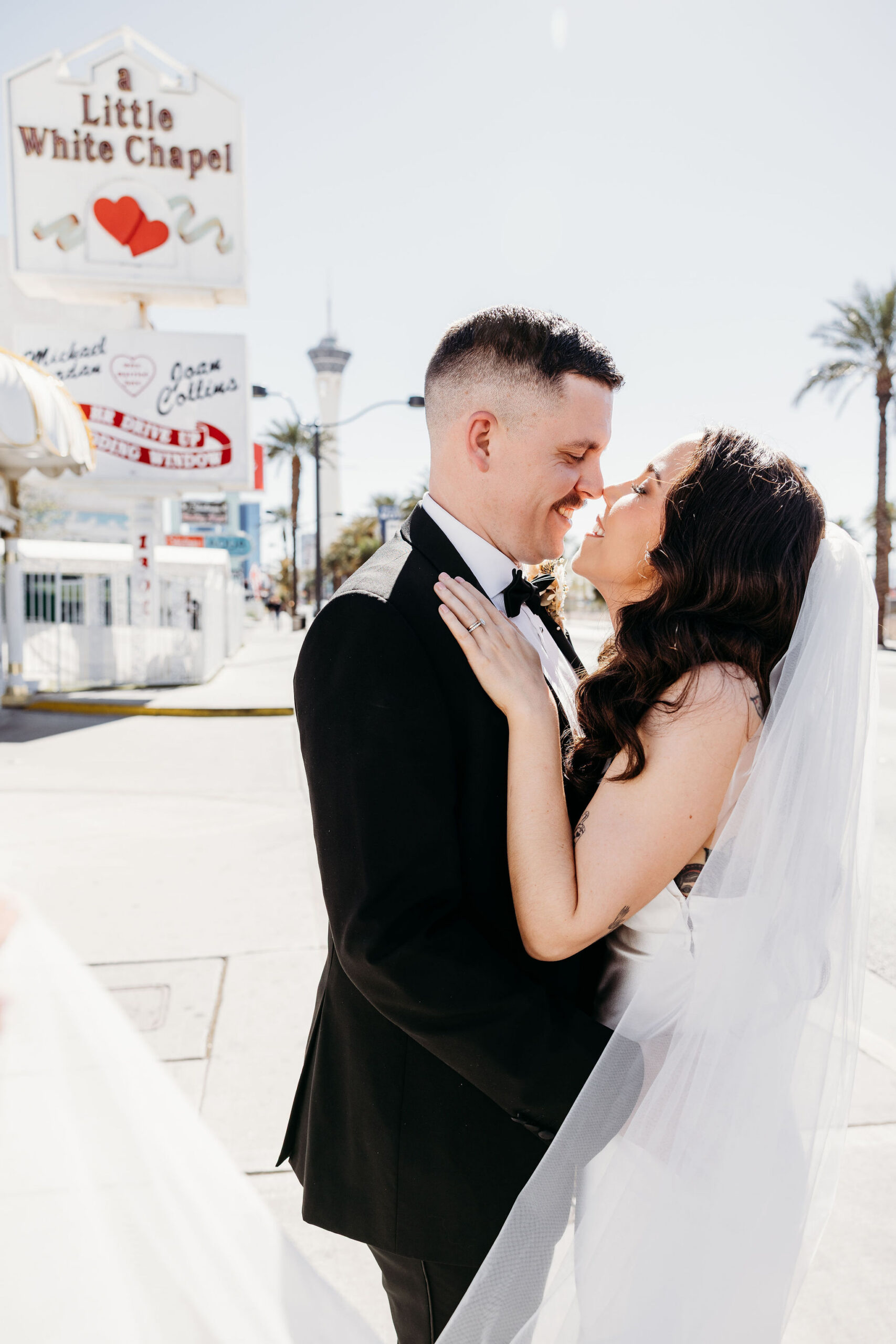 newlyweds smiling at each other during their photoshoot