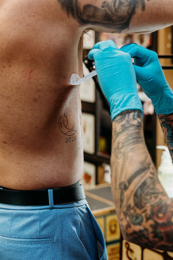 couple getting a tattoo during their elopement
