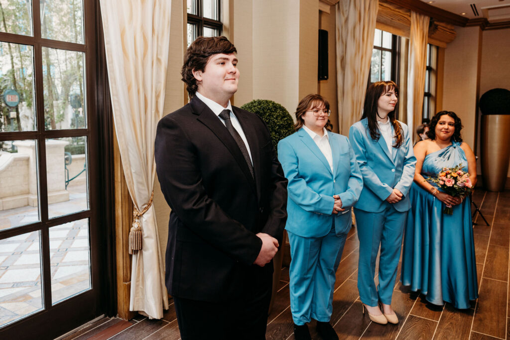 Groom, watching the bride walk down the aisle