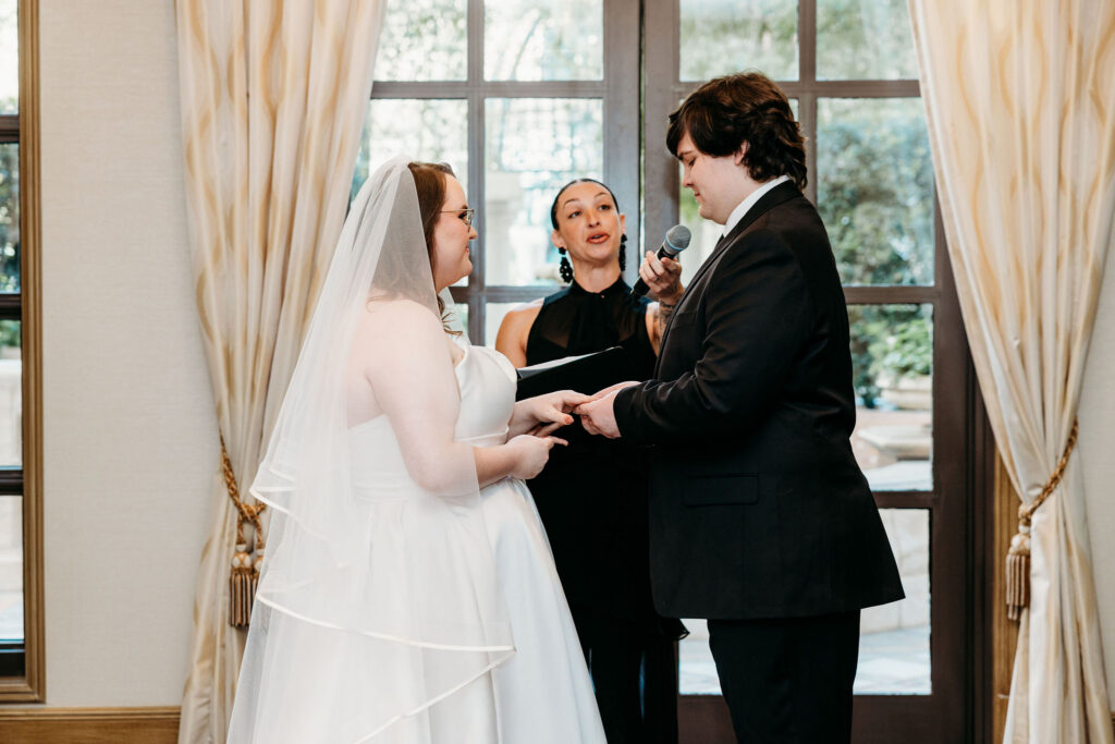 Bride and groom holding hands during their wedding ceremony